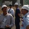 Individuals wearing hard hats standing in critical infrastructure facility