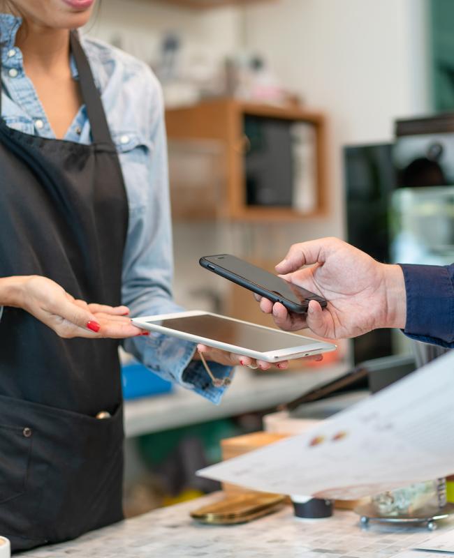 A small business worker making a transaction with a customer