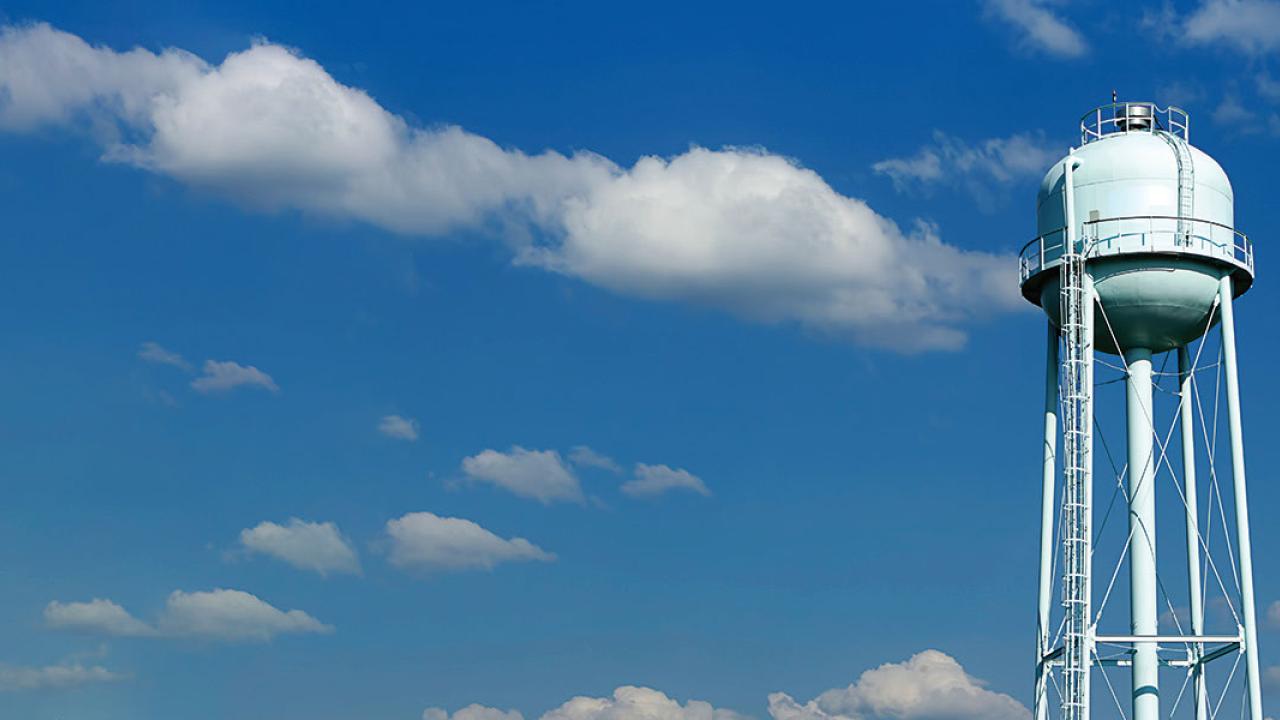 Water tower against a blue cloudy sky