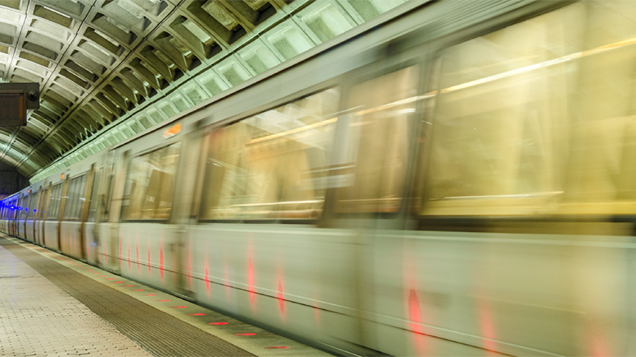 Image of speeding train in DC Metro station taken from standing platform