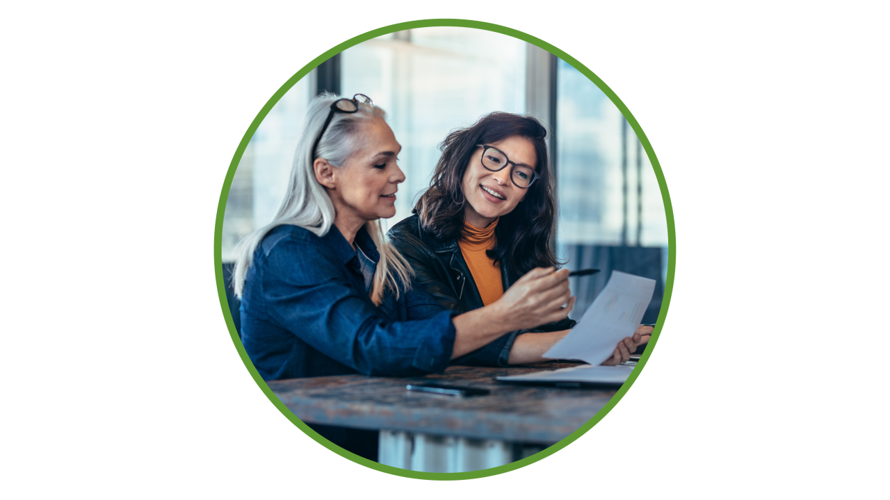 Two women review documents