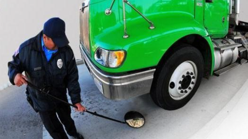 A DHS worker taking protective bomb threat measures