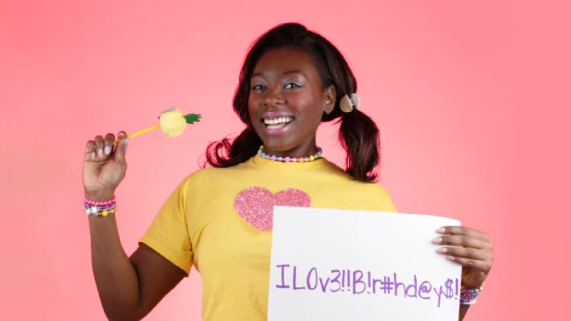 A happy woman holding a complex password