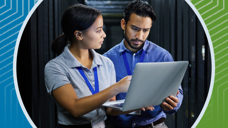 coworkers looking at a laptop