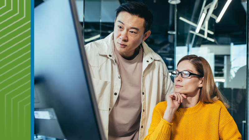 coworkers gather around a computer 
