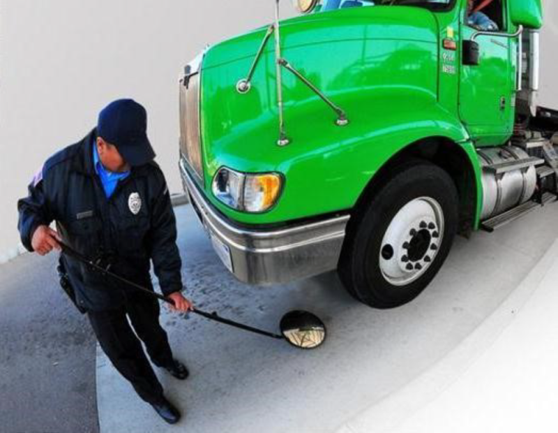 A DHS worker taking protective bomb threat measures