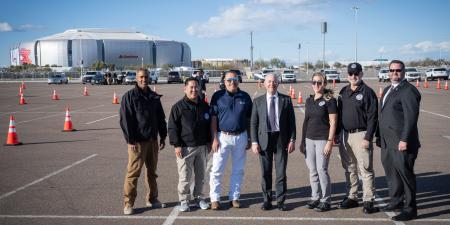 CISA Region 9 PSA and others pose with DHS Secretary Alejandro Mayorkas in front of State Farm Stadium in Glendale Arizona
