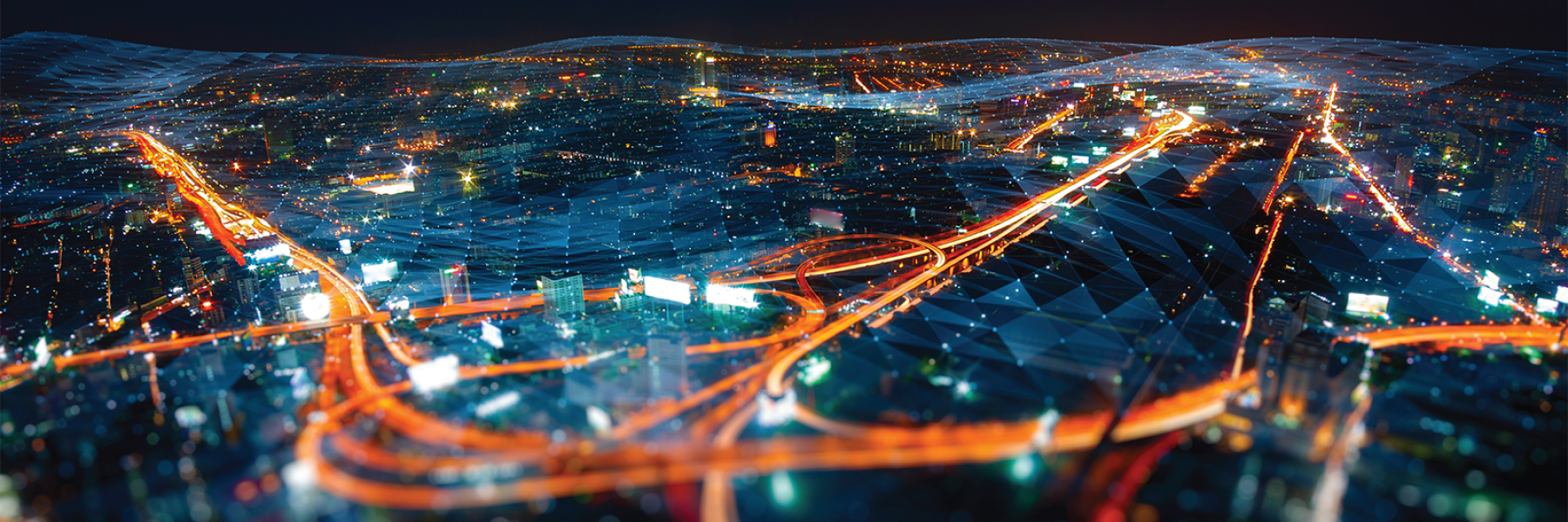 Aerial view of city at night with glowing network and communication lines
