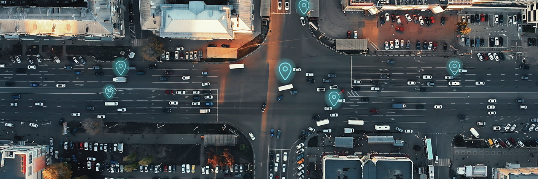 Aerial view of city street with location pings on cars