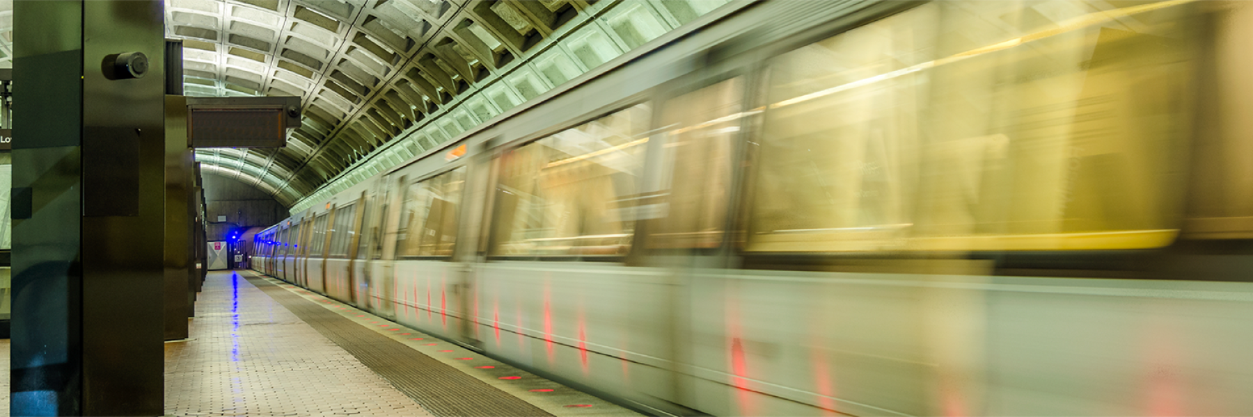 Image of speeding train in DC Metro station taken from standing platform