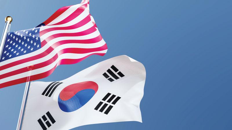 USA and South Korea flags waving in the wind
