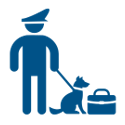 Police officer holding a dog on a leash sitting next to a briefcase.