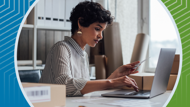 Woman at work entering information in her laptop