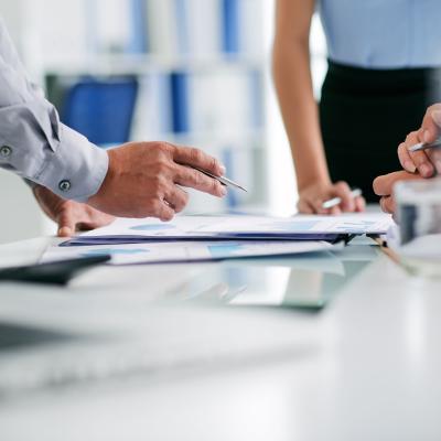 Business people reviewing work on a table